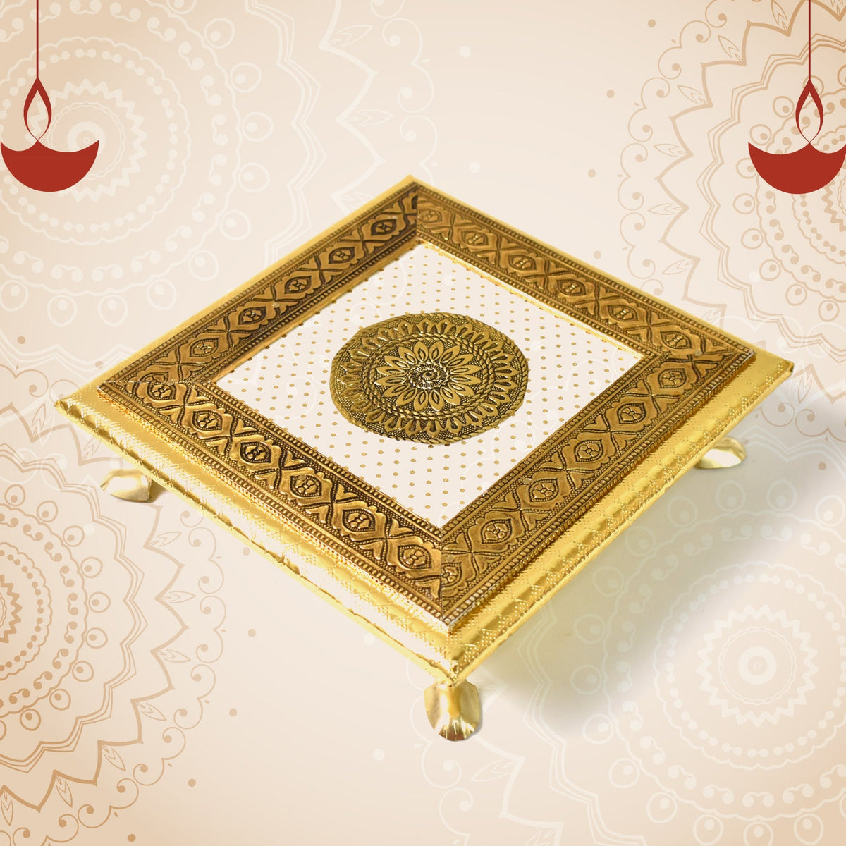 A golden square pooja chowki with a white and gold mandala design, set against a background with faint patterns and two red