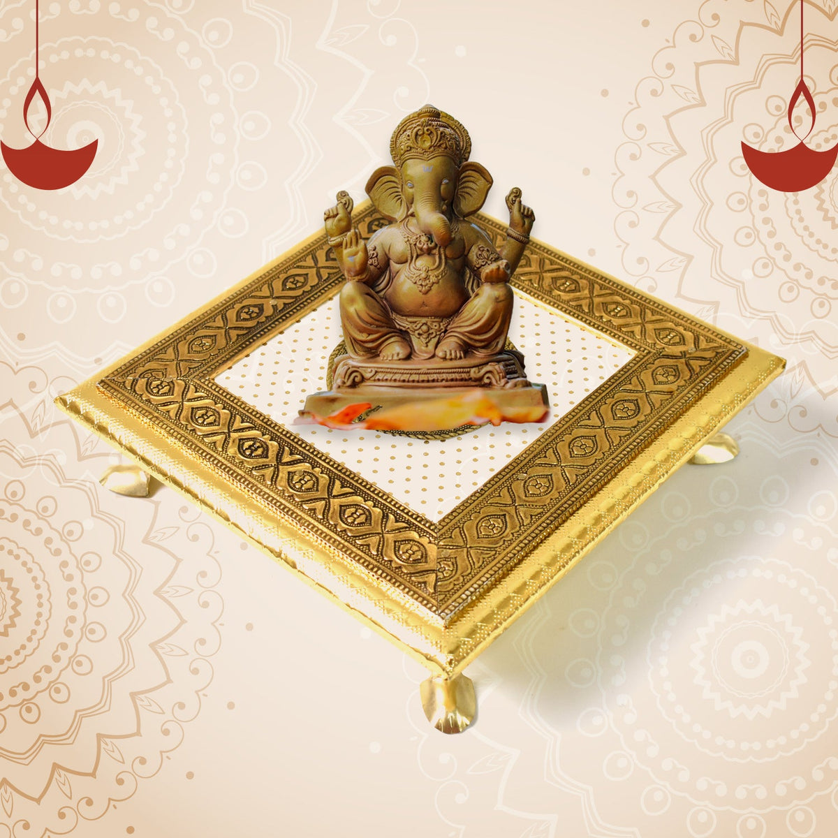 A golden square pooja chowki with a Ganesha idol on top, against a background with faint patterns and two red oil lamps.