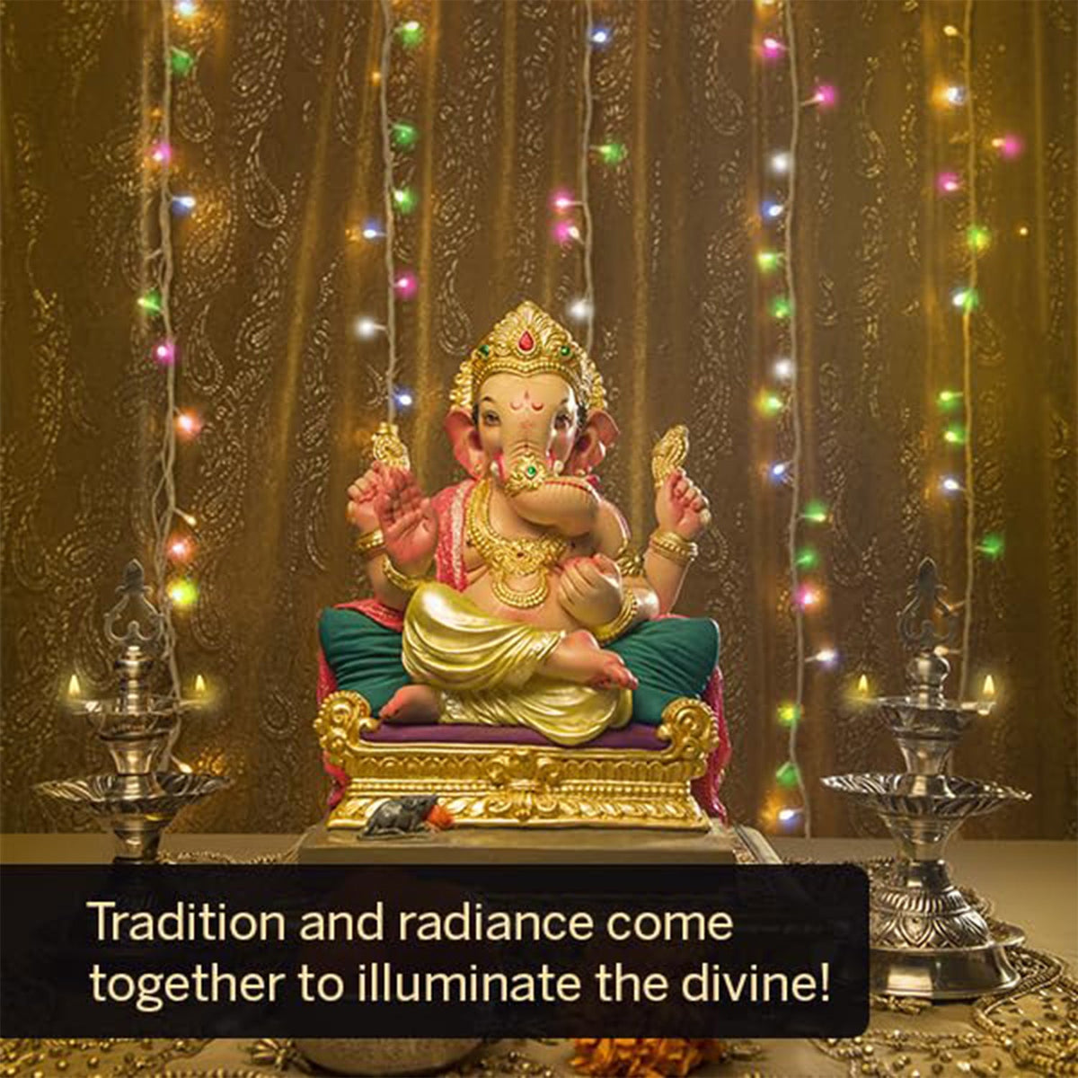 A Ganesha idol sits on a golden throne, flanked by two silver lamps, with colorful string lights in the background.
