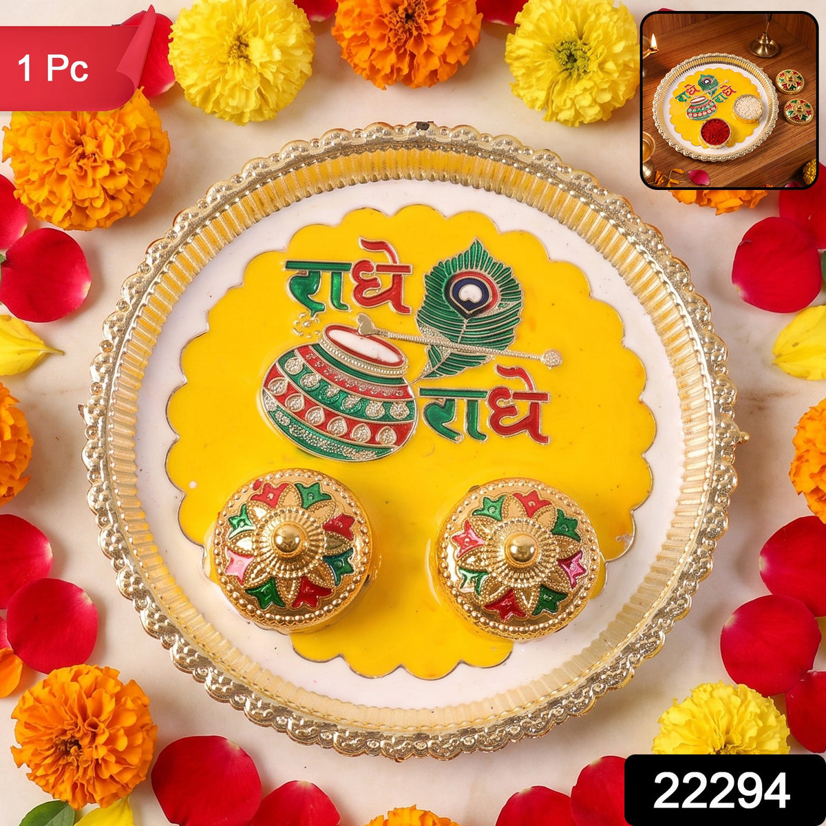 A silver and yellow Radhe Radhe pooja thali set with two small decorative containers, surrounded by marigolds and rose,